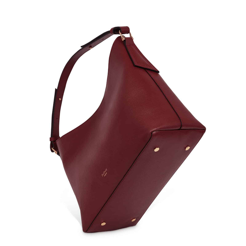 Burgundy Leather designer British made Shoulder bag with base studs and adjustable handle Made in England UK